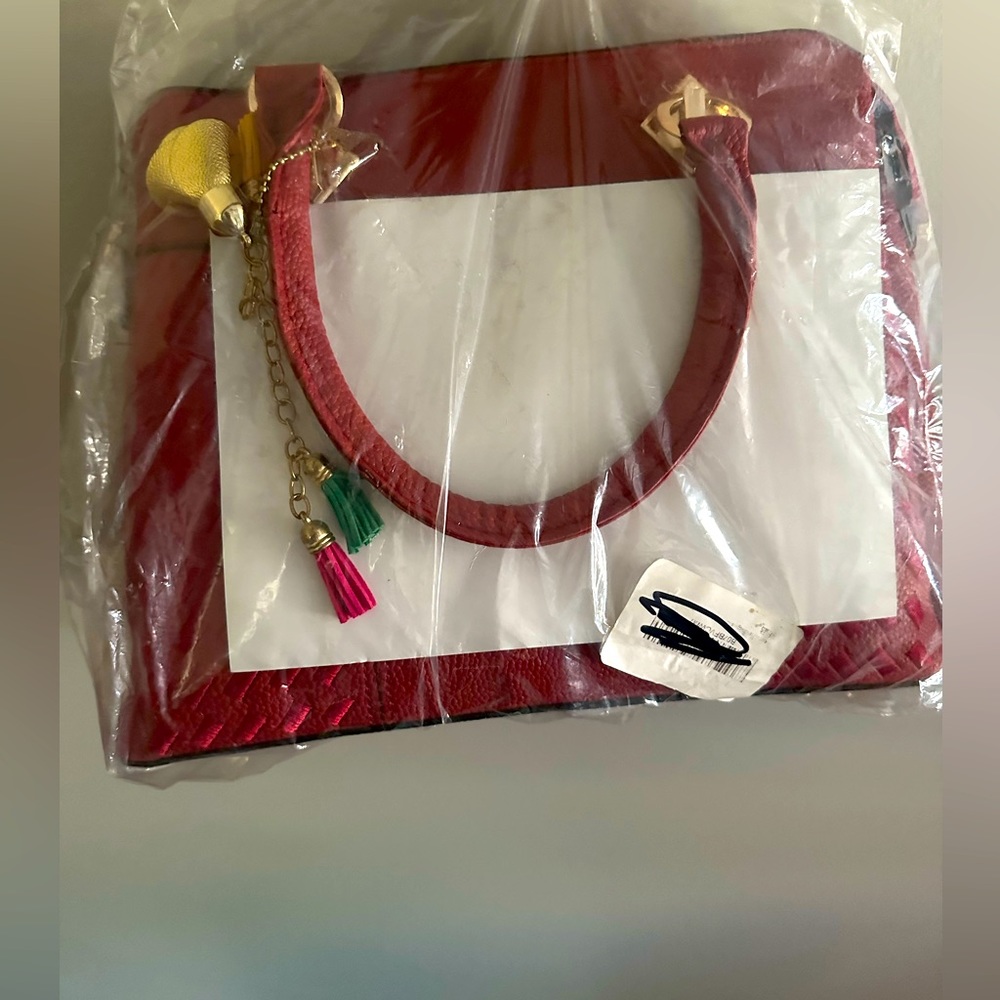 NWT in packaging still leather handbag with strap and many compartments